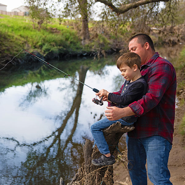 Father and son fishing in a creek